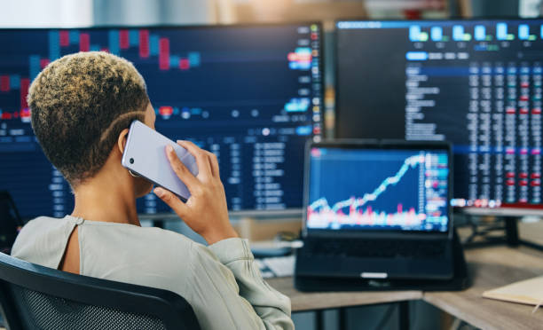 Woman, phone call and broker consulting in trading, stock market or discussion for online finance at office. Business female person or financial advisor talking on mobile smartphone in advice or help